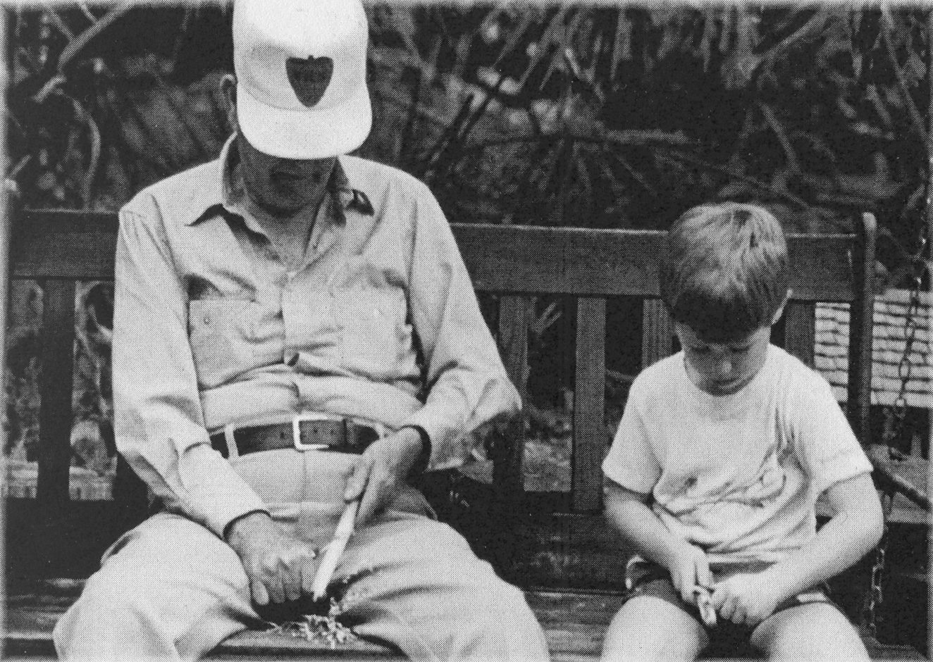 Grandfather and grandson whittling